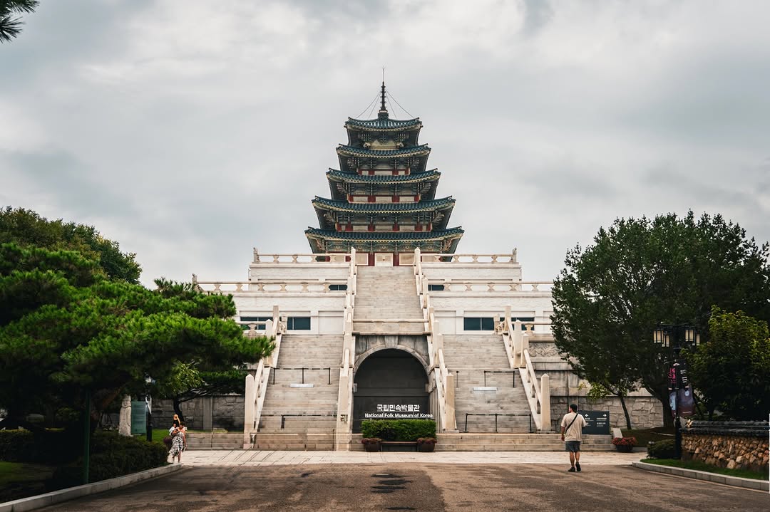The pagoda of the National Folk Museum of Korea under a cloudy sky.