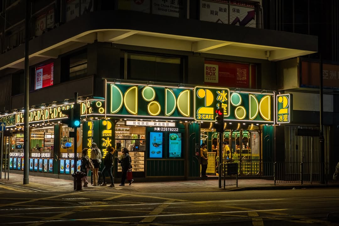 A neon corner shop on a street in Central, Hong Kong, at night.