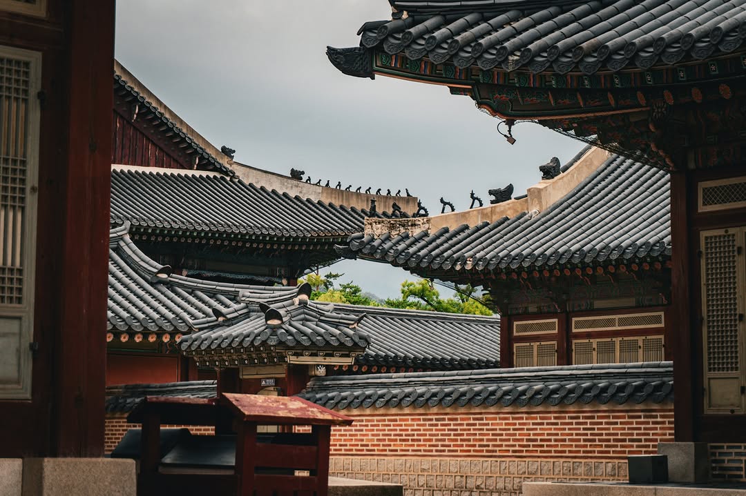 Layered grey palace roofs and ridge figures at Gyeongbokgung, Seoul.